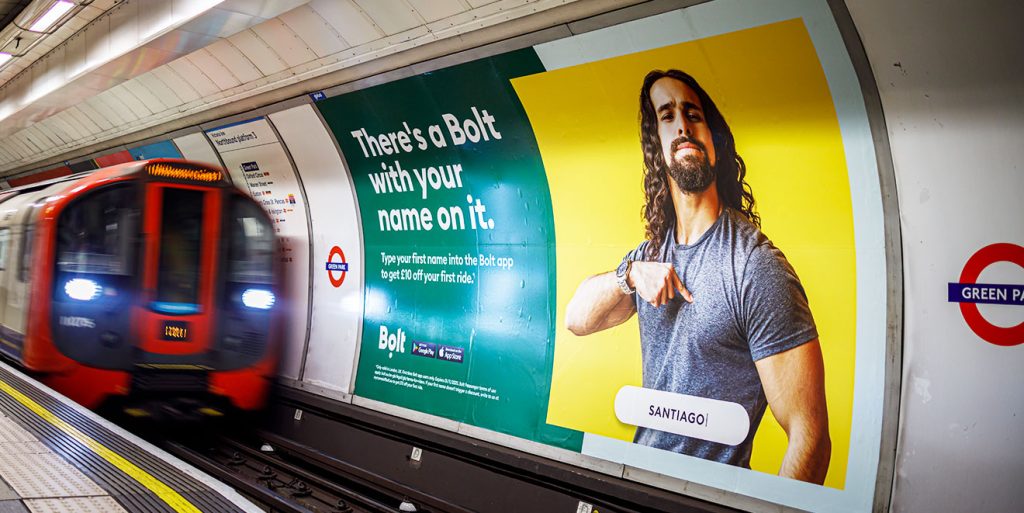 An advert for Bolt appears across the track on the London Underground.
